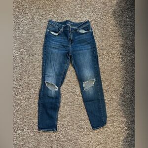 Dark wash jeans with holes at knee